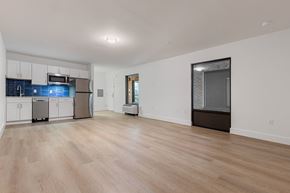 Charlotte apartment for rent - A kitchen with white cabinets and a wooden floor.