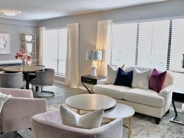 Little Rock apartment for rent - A living room with a white couch and a round table.