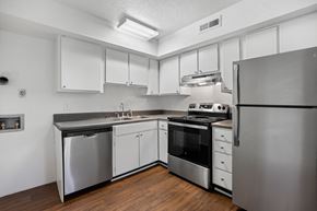 Wilmington apartment for rent - an empty kitchen with stainless steel appliances and white cabinets