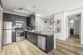 Columbus apartment for rent - A modern kitchen with a refrigerator, oven, and sink.
