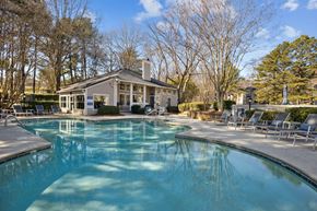 Charlotte apartment for rent - a swimming pool with a house in the background