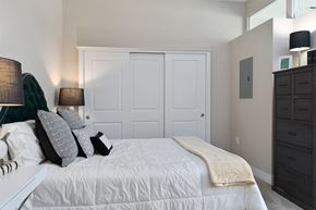 Dublin apartment for rent - a bedroom with a white bed and white closet doors at Hayden Lofts, Dublin, OH