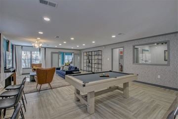 Little Rock apartment for rent - a rec room with a pool table and a living room with chairs