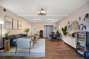 Rock Hill apartment for rent - A modern living room with a grey sofa, a coffee table, and a kitchenette in the background.