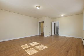 Raleigh apartment for rent - A room with wooden floors and white walls.
