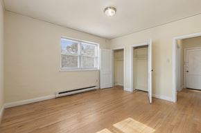 Raleigh apartment for rent - A room with a window, a door, and a wooden floor.