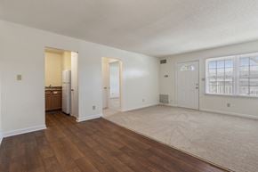 Raleigh apartment for rent - A spacious room with wooden floors and white walls.