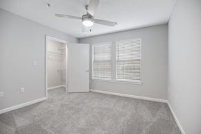 Raleigh apartment for rent - an empty bedroom with a ceiling fan and a bathroom at Midtown Crossing in NC 27609