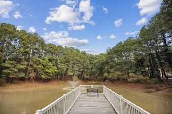 A bridge over a body of water with a bench on it