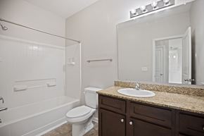 Carthage apartment for rent - A white toilet sits next to a sink in a bathroom.