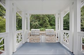 Cary apartment for rent - A white gazebo with a stone wall and grill in the middle.