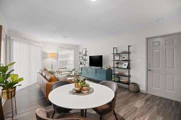 Cary apartment for rent - A living room with a white table and brown chairs.