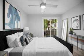 Cary apartment for rent - A bedroom with a large bed and a ceiling fan.