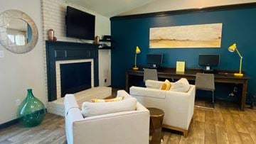Raleigh apartment for rent - A living room with a fireplace and a painting on the wall.