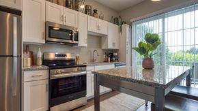 Glen Allen apartment for rent - A kitchen with a stove top oven and microwave above it.
