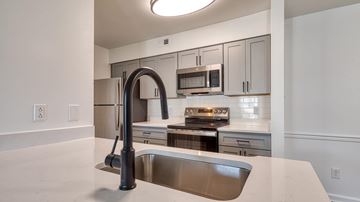Virginia Beach apartment for rent - A modern kitchen with a stainless steel sink and appliances.