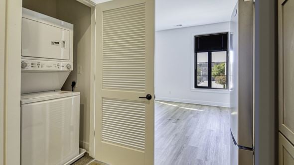 Newport News apartment for rent - A white refrigerator is in a kitchen next to a white door at Aviator Lofts, Virginia 23602