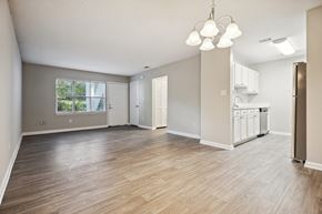 Knightdale apartment for rent - an empty living room with a kitchen in the background