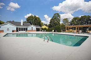Knightdale apartment for rent - a swimming pool with a house in the background