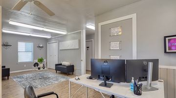 Virginia Beach apartment for rent - A room with a desk, chairs, and a ceiling fan.