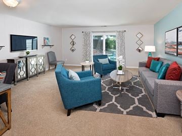 Richmond apartment for rent - A living room with a blue chair and a grey couch.