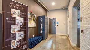 Richmond apartment for rent - A hallway with a sign that says "Riveting at its finest" and a blue sofa.