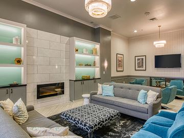 Richmond apartment for rent - A modern living room with a grey couch and a fireplace.