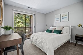 Charlotte apartment for rent - a bedroom with a bed and a door to a balcony