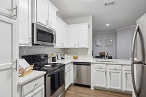 Charlotte apartment for rent - A kitchen with white cabinets and appliances.