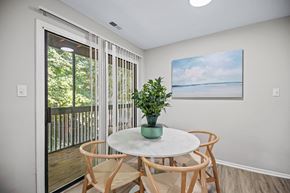 Charlotte apartment for rent - a dining area with a table and chairs and a door to a balcony