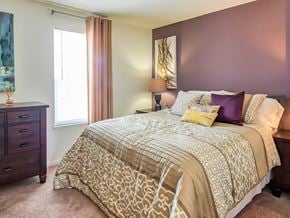 White Marsh townhouse for rent - A bedroom with a large bed and a dresser.