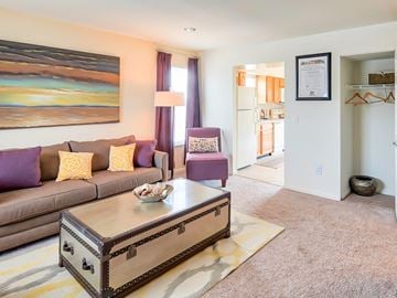 White Marsh townhouse for rent - A living room with a brown couch and a painting on the wall.