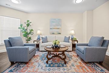 Raleigh apartment for rent - A living room with a rug and four chairs.