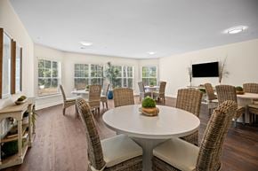 Raleigh apartment for rent - a living room with a table and chairs and a television
