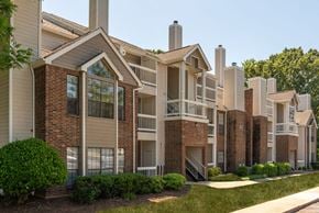 Raleigh apartment for rent - Apartment complex with brick and beige buildings.