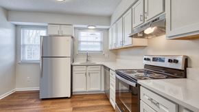 Virginia Beach apartment for rent - A kitchen with a stainless steel refrigerator and a white oven.
