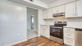 Virginia Beach apartment for rent - A kitchen with white cabinets and a stainless steel oven.