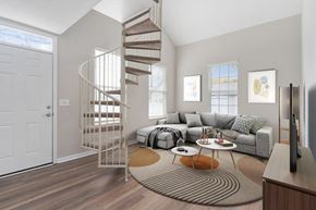Columbus apartment for rent - a spiral staircase in a living room with a couch at Orleans Apartments, Columbus, Ohio