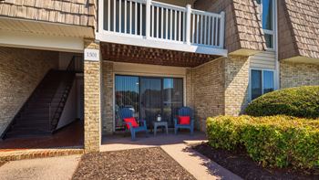A patio with chairs outside of a building
