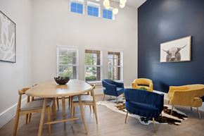 Charlotte apartment for rent - a dining room with a table and chairs and a bull painting on the wall