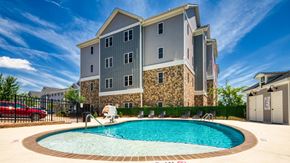 Lynchburg apartment for rent - a swimming pool in front of an apartment building