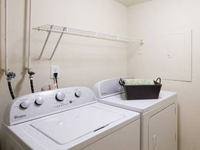 White Marsh townhouse for rent - A white Whirlpool washing machine and dryer in a small laundry room.