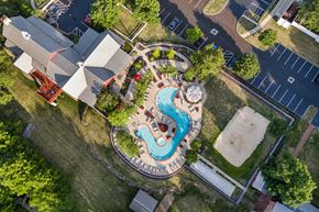 Columbus apartment for rent - an overhead view of a swimming pool in a backyard with a house and a neighborhood at The Charleston, Ohio
