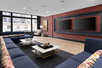 Columbus apartment for rent - A living room with a long sofa and a coffee table.