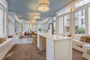 Dublin apartment for rent - A kitchen with a white counter and wooden chairs. at Times Square, Dublin, 43016