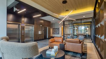 A lobby with couches and chairs and a table