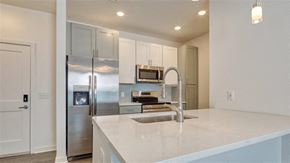 Norfolk apartment for rent - a kitchen with stainless steel appliances and white cabinets at The Port at East Beach Apartments and Marina, Virginia