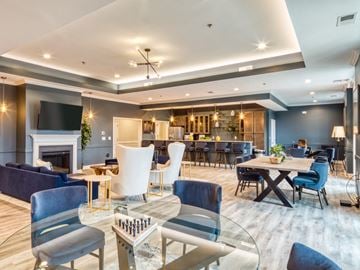 Fredericksburg apartment for rent - a living room with couches tables and chairs and a fireplace