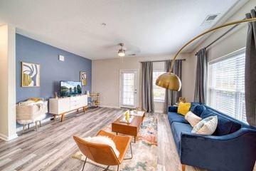 Suffolk apartment for rent - A living room with a blue couch and a wooden floor.