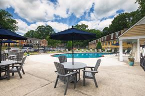 Williamsburg apartment for rent - A pool area with a table and chairs and umbrellas.